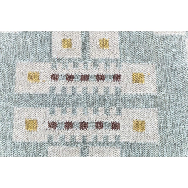 This modern Swedish flat-weave rug presents a refined geometric composition inspired by classic Scandinavian design. Set...