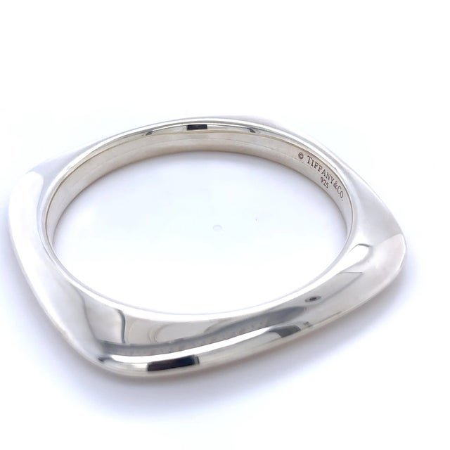 A distinctive vintage Tiffany & Co. square bangle bracelet crafted in sterling silver, featuring a bold geometric profile...