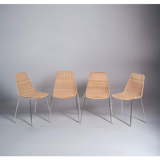 Beautiful midcentury set of four wicker and chromed metal Italian chairs. These amazing pieces were produced in Italy...