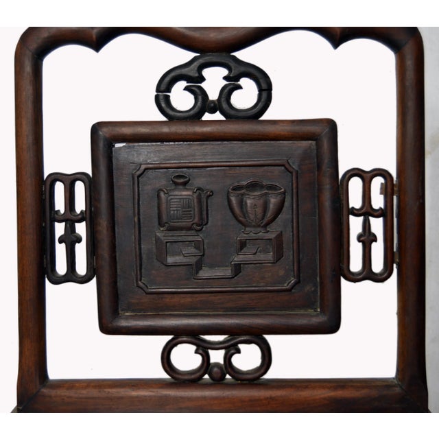 A yumu wood Chinese accent chair with hand-carved splat, fretwork patterns and lacquered finish. This Chinese carved chair...