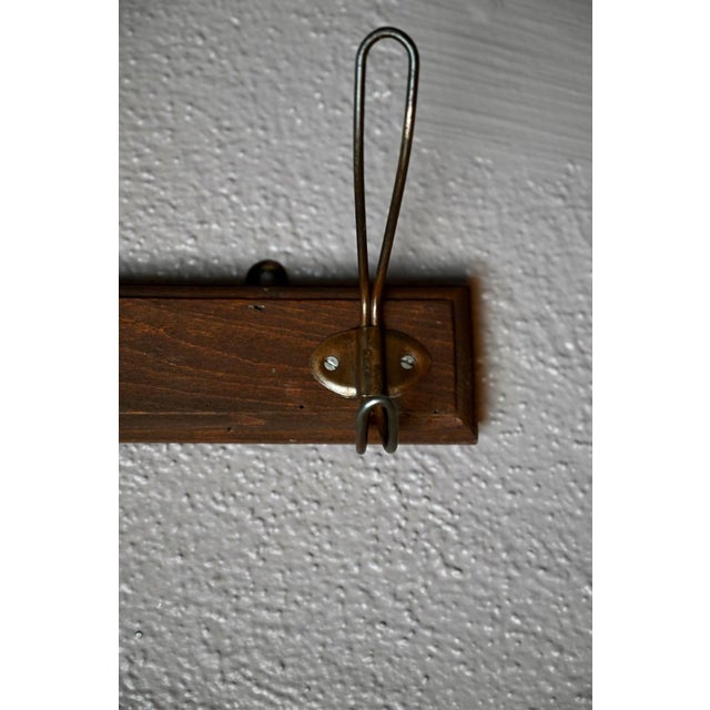 This 1940s coat rack evokes the charm of a cozy corner bistro! Made of wood and metal wire, its vintage hooks are perfect...