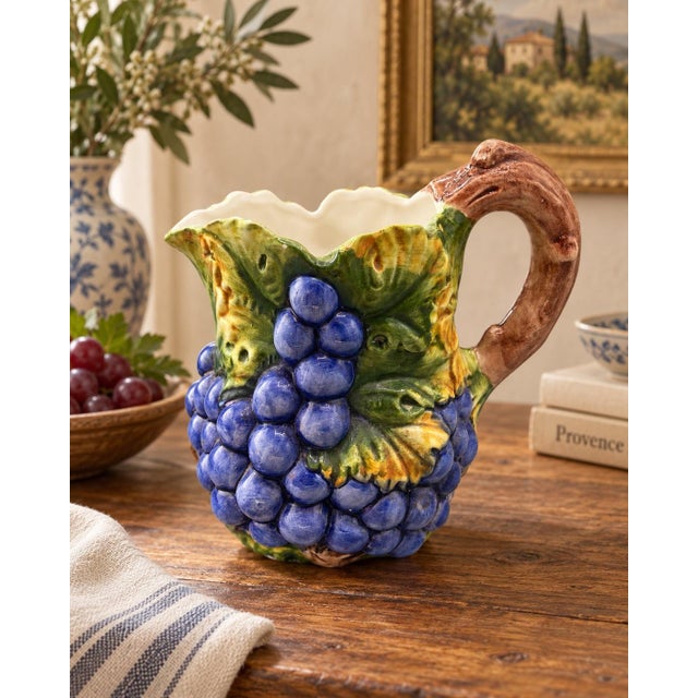 Beautiful vintage hand-painted ceramic pitcher made in Bassano, Italy. Features a raised grapevine design with clusters of...