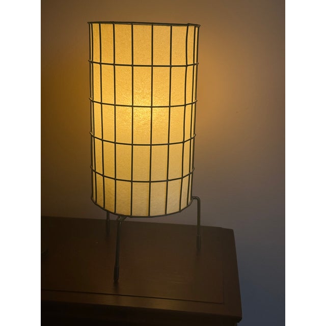 A pair of vintage mid-century modern wire cage table lamps attributed to Paul Mayen for Habitat. They feature cylindrical...