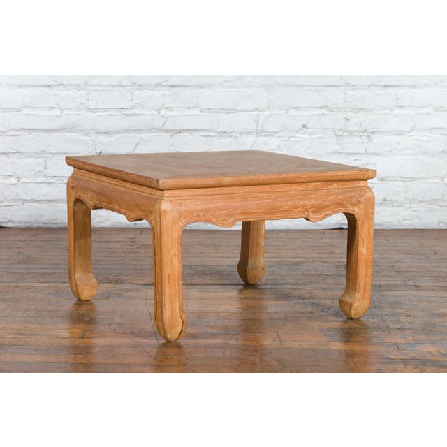 A vintage Ming Dynasty style Thai teak wood low drinks table from the mid-20th century with natural patina, carved apron...