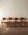A vintage set of four french brutalist dining chairs in solid elm and cognac leather, made by maison regain in france...