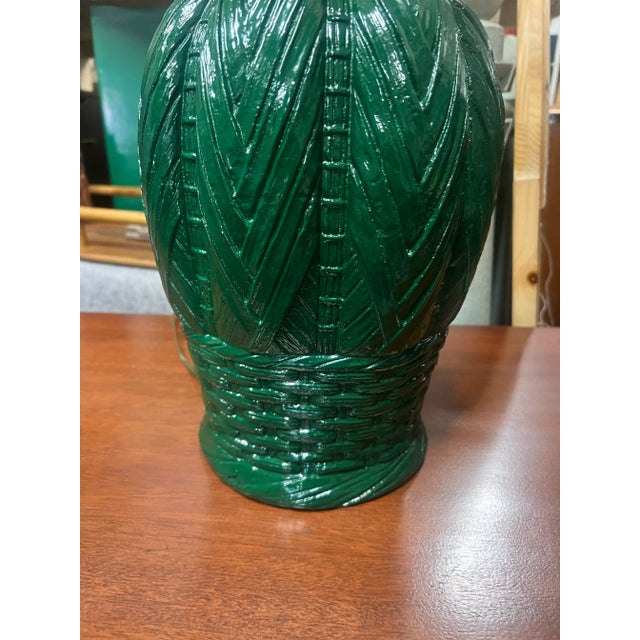 A pair of palm beach chic emerald green lacquered ceramic table lamps with an interesting grouping of different basket...