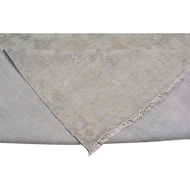 Hand-knotted with care using traditional rug-making techniques, this wool rug blends timeless craftsmanship with a modern...