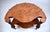 A French Regency style kidney-shaped tea table or side table constructed of striking book matched burl walnut, featuring...