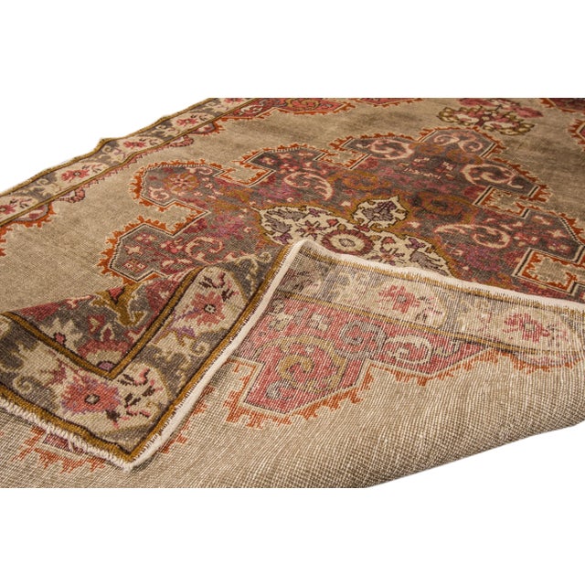 Beautiful vintage Chinese Oushak hand-knotted wool rug with a brown field. This piece has gray, beige, and burnt orange...