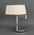 Mid-Century Modern Chrome Swing-Arm Table Lamp, with two bulb fittings and an Artemis Studios white linen shade. Arm fully...