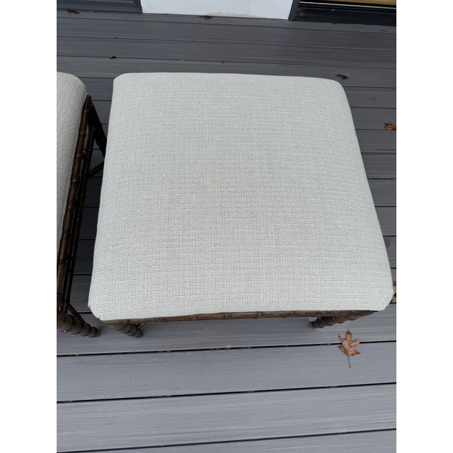 Attractive pair of ottomans upholstered in a cream and gray tweed fabric make for easy neutral additions to any room. Note...