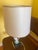 This is a vintage porcelain lamp featuring elegant neoclassical design elements, including a fluted base and a Greek key...