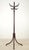 Victorian style dark toned wood coat tree rack with both turned and bentwood stylings details. The central pole is a...