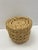 Delicate and intricate textured basket made of beautifully woven elephant grass. This casual lidded basket would be a...