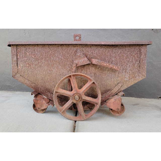 Heavy gauge steel industrial cart / dolly with large cast iron spoke wheels. Four smaller castor wheels. Probably used in...