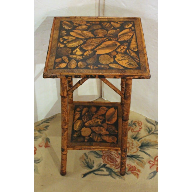 Circa 1870s square 2-tier bamboo side table, English. Straight legs & bold architectural struts. Well figure bamboo. The...