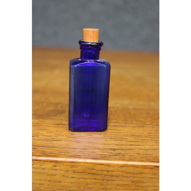 Rare antique cobalt blue glass poison bottle with an embossed skull and crossbones above the words “POISON / TINCT /...