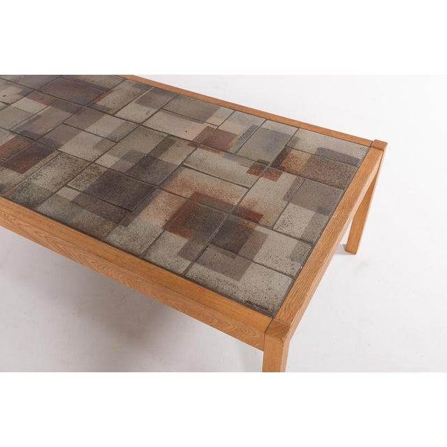 Modern rectangular coffee table from Sallingboe with ceramic tile top inlay and oak frame. The tiles are handcrafted by...