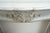 Antique Louis XV-style fireplace in white Carrara marble dating from the early 19th century. The lintel is slightly arched...
