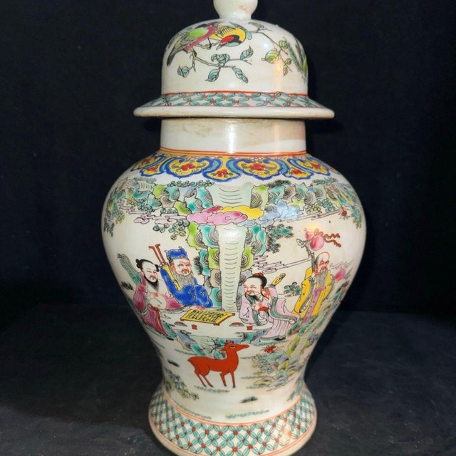 A beautiful pair of Chinese Famille Rose porcelain "General Jars." The white ground is finely hand-painted with a vibrant...