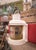 An early 1900s navigation ship lantern featuring a glass fresnel lens and steel metal frame.