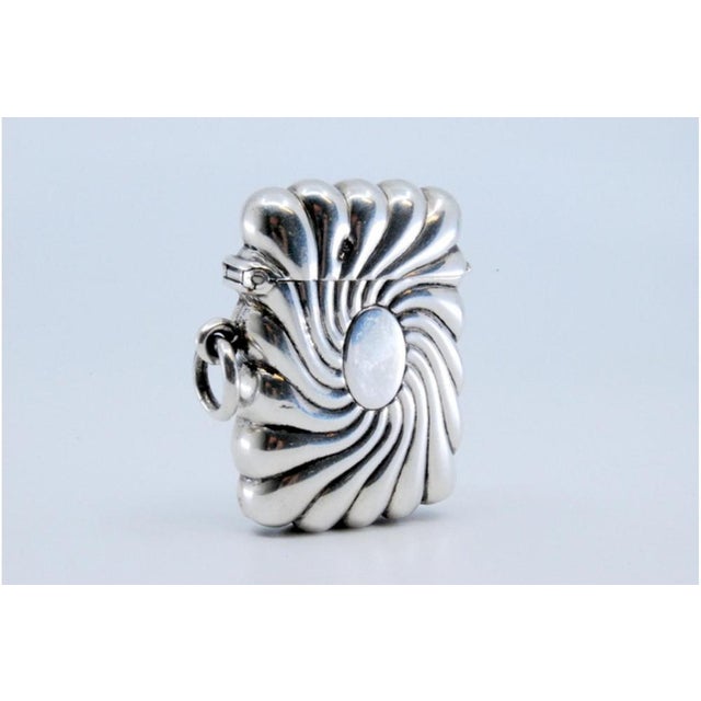 Vortex-Shaped Embossed Silver Matchbox with Monogram Card, in Very Good conditions. Designed 1890 to 1919 This piece has...