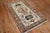 Persian Heriz tribal scatter rug consisting of an ivory field with dominant accents in brown Measures: 3'3” x 5'11”.