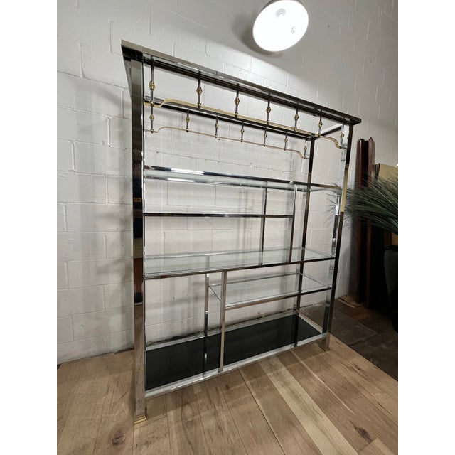 A monumental vintage chrome, brass and glass display étagère dating to the early 1980s. Measuring an impressive 60 inches...