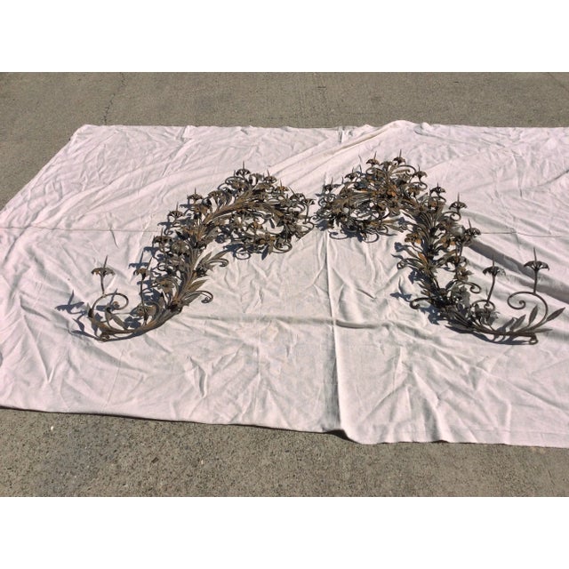 Large Antique ornate pair of scrolling iron wall pricketts. These are hand wrought and one is a single piece and the other...