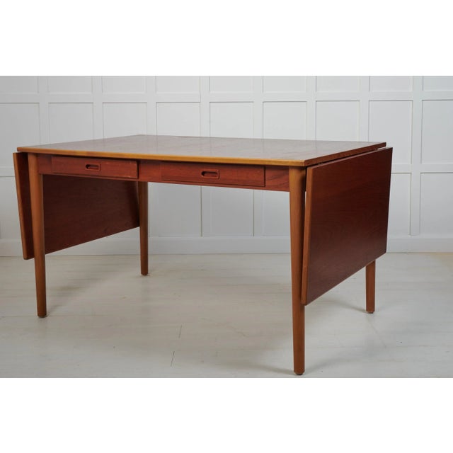 Scandinavian modern desk or dining table by Nils Jonsson for Troeds. Made in Sweden around 1960 with a table top in teak...