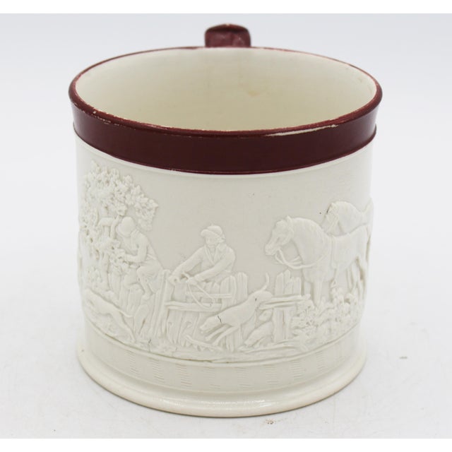 Circa 1805-1810 Davenport hunt motif stoneware mug, England. Stoneware in natural white with dark brown glazed rim....