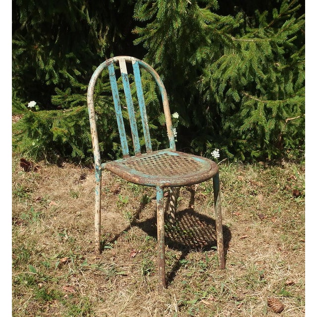 Chairs in bent iron. Backrest adorned with three steel bands, seat in iron perforated with diamonds. Designer Robert...