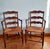 Pair of wide, rustic Provençal-style armchairs, late 19th/early 20th century. Wide, straw-seated seats with two armrests...