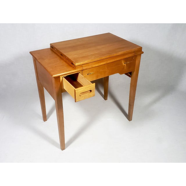 This item was and is a vintage Mid-Century Modern sewing desk. It is designed to hold a sewing machine, which can then be...