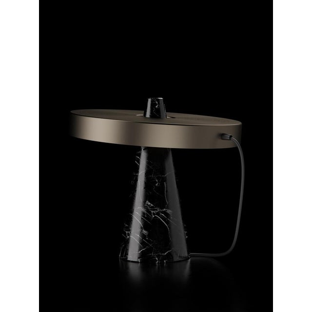 Table lamp with Marquinha black stone base and bronze lightshade. The light shade is disconnected from the stone base and...