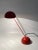 A table lamp *consists of two hemispheres, bright red painted *model: minikini *design: barbieri & marianelli...