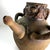 Expressive ceramic pitcher by Louis Mendez, featuring a sculpted bearded face, applied arms, a rounded body, and a curved...