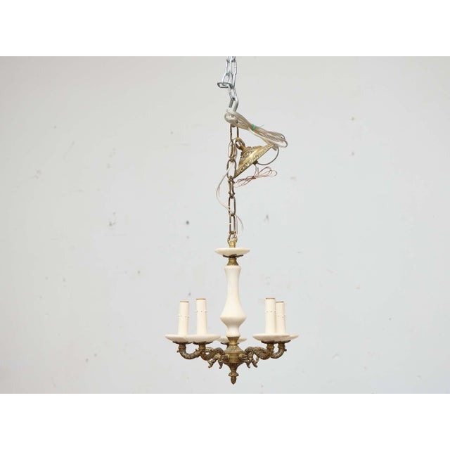 A refined Italian Midcentury chandelier pairing smooth alabaster with finely cast gilt bronze. The composition centers on...