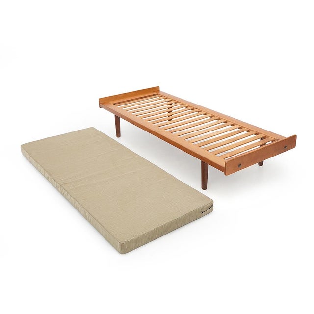 “G19” model daybed designed by Ejvind Johansson for FDB Møbler in the 1960s. Solid wood frame with exposed slats and...