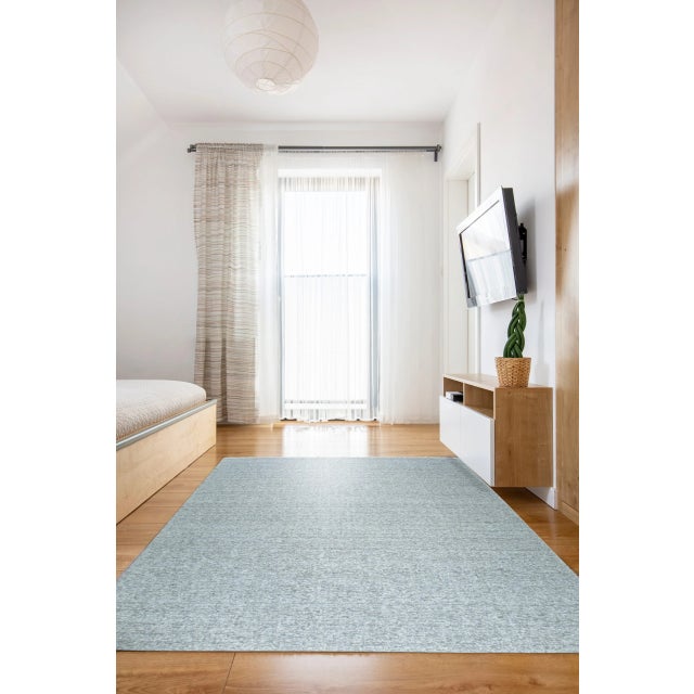 Opulent Alluring Silver Handmade Wool Rug, Country of Origin: India. This exceptional piece showcases a sophisticated...