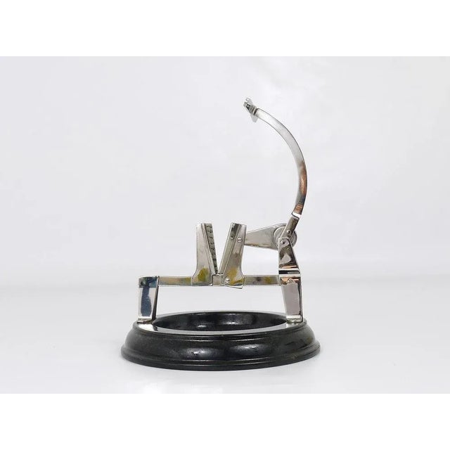 A chromed table or bar nutcracker on an black/brown enameled bowl from the 1920s, executed by wmf - württembergische...
