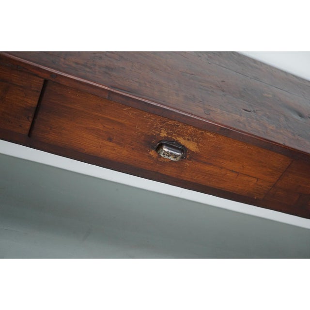 The table was made in solid teak with beautiful grain pattern. It has a warm color with deep gloss and the table shows...