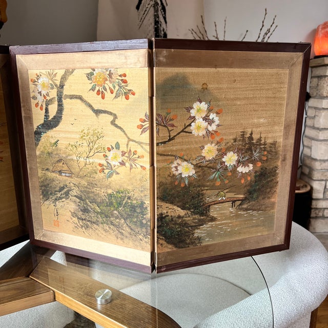 Decorative pair of hand-painted silk tabletop folding screens in the Japanese byōbu tradition. This set consists of two...