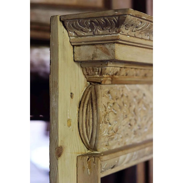 Antique, petite scale, English Georgian style 19th century pine mantle. The pulvinated frieze features an intricately...