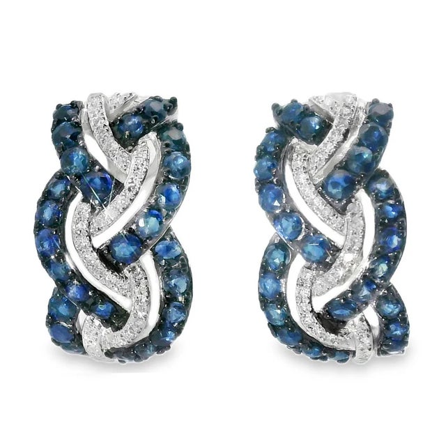 These 14K White Gold Diamond Sapphire Huggie Braided Earrings are a stunning blend of elegance and sophistication. The...