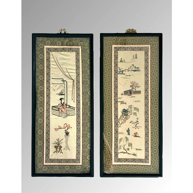 A pair of earlier silk on silk hand embroidered Chinoiserie panels with mat black frames. Wide brocade surround of...