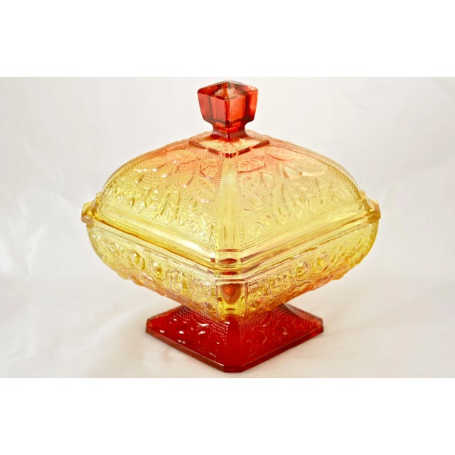 Large 7 inch tall vintage amber gold to red orange fall color gradient glass pedestal domed lid box with an ornate acorn...