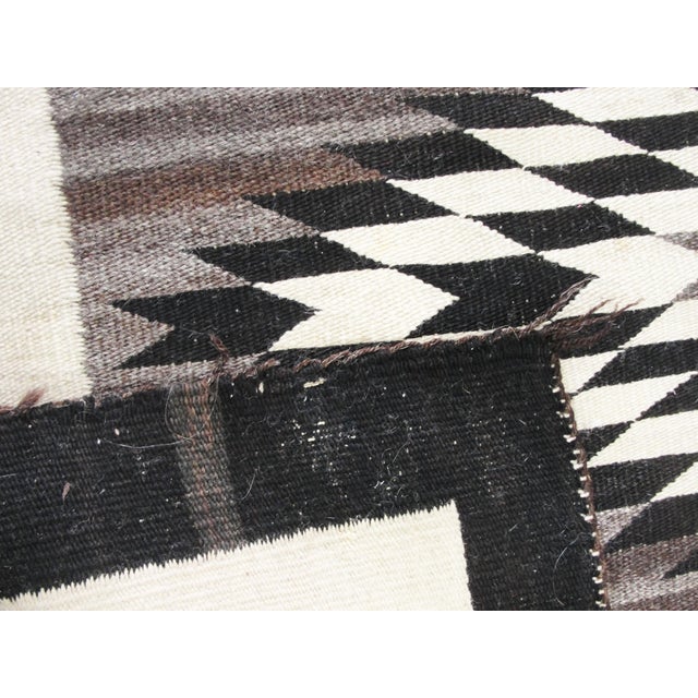 An exceptional early Navajo weaving distinguished by its dramatic geometric composition and sophisticated use of natural,...