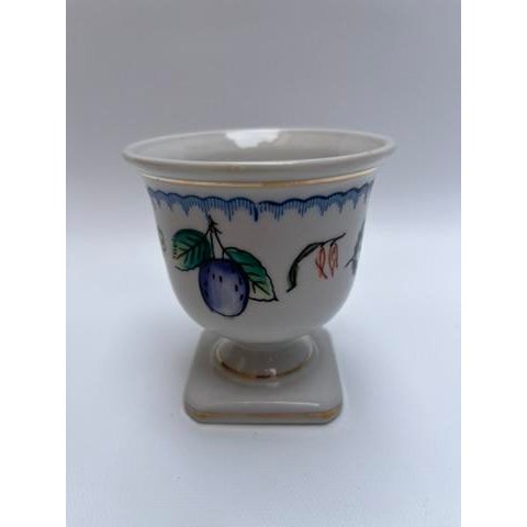 A single antique round porcelain cup with square foot featuring gilt trim and decoration including flowers and fruit.