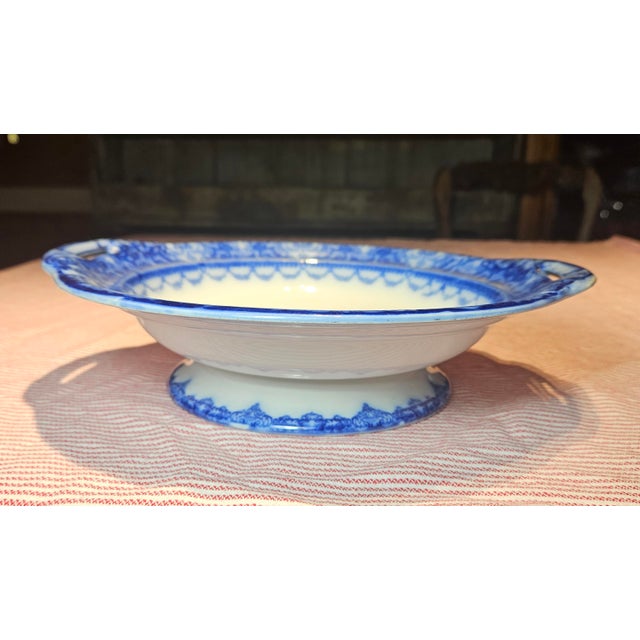 This double handled pedestal bowl by Royal Doulton in the "Watteau" pattern showcases a charming pastoral scene inspired...